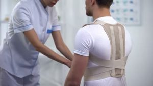 man being fitted with back brace