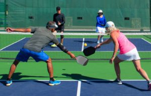 older couple playing pickleball after spine surgery